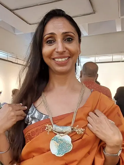 This stunning client is wearing one of my bold, sculptural necklaces. I love creating statement jewellery that is both artistic and wearable.