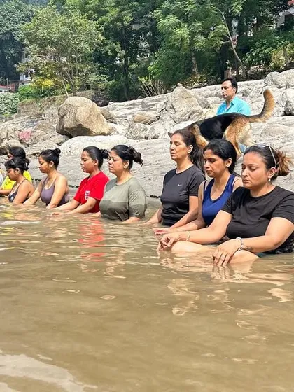 Group meditation in the sacred waters of the Ganga. This practice of 'Jal Dhyan' is a powerful way to connect with nature and purify the mind.