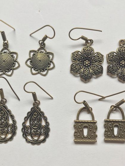 More of my lightweight drop earrings in antique gold finish. These feature floral and geometric designs like locks, making them fun and quirky accessories.