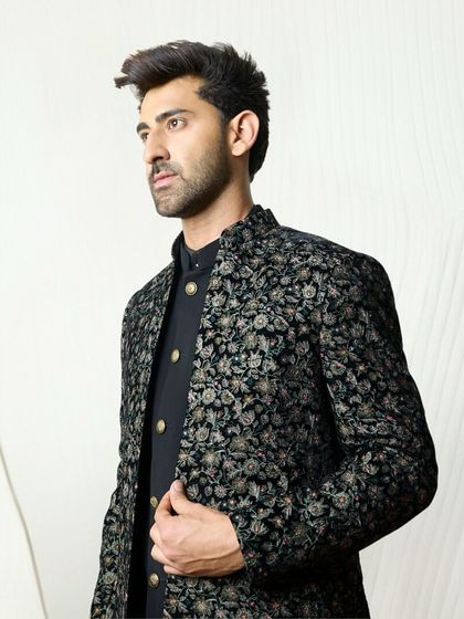 The black floral embroidered jacket set is a versatile choice for any celebration. The dark, sleek canvas makes the floral details stand out beautifully.