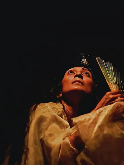 A powerful still from a solo performance, capturing a moment of looking towards hope. The stark contrast between light and dark is a recurring theme in my work, representing the dualities of life.