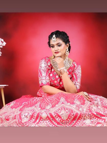 A pensive and beautiful shot, highlighting the flawless makeup and intricate jewellery.