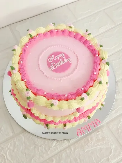 A vintage pink beauty for a 90th birthday, complete with delicate piping, white pearls, and handcrafted flowers. A sweet celebration of 90 wonderful years.
