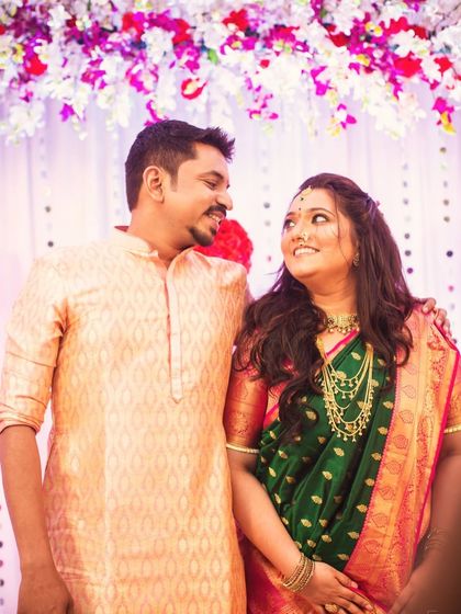 A lovely couple portrait from an engagement party. The bride's makeup is radiant, and her open hairstyle is perfect for the celebratory atmosphere.