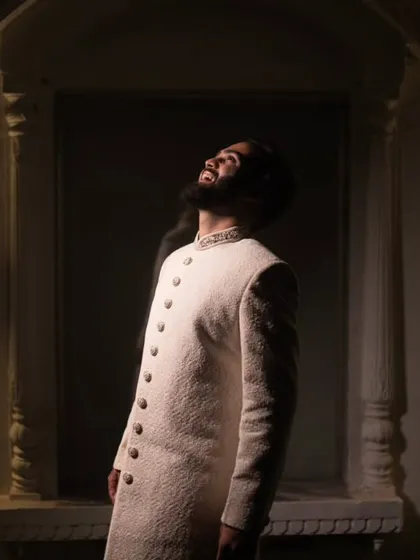 A groom's portrait is about capturing his quiet confidence and anticipation. This shot uses dramatic lighting to create a powerful, stylish image that tells a story of the man he is on his wedding day.