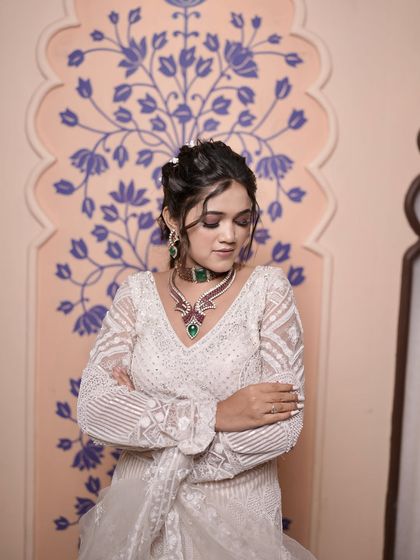 This model showcases an elegant updo with soft, face-framing tendrils. It's a versatile look that works well for any formal event.