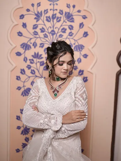 This model showcases an elegant updo with soft, face-framing tendrils. It's a versatile look that works well for any formal event.