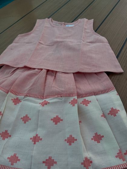 A flat lay of our cleverly designed skort set. You can really see the beautiful handwoven texture and the thoughtful construction that makes it perfect for all-day play.