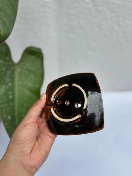 The bottom of our soap dish is unglazed and features our studio stamp, so it won't slip on your counter.