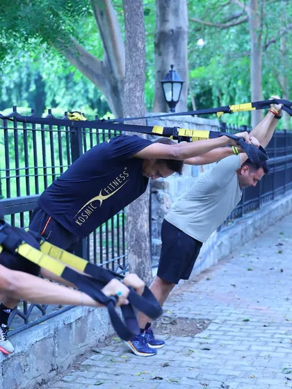 My coaching is not just about logging miles. We build strong, resilient athletes from the ground up with functional strength training. Here, our group uses TRX for a full-body workout, improving core stability and muscular endurance which is crucial for running.