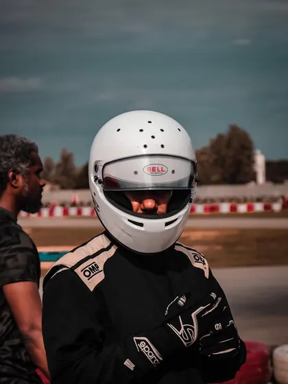 A close-up of a driver in his helmet.