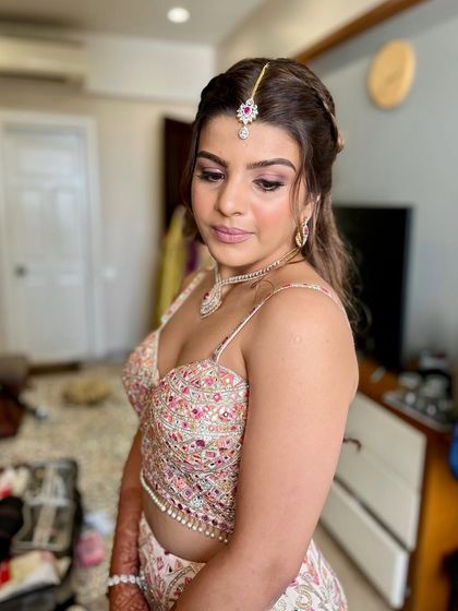 All glammed up and ready for the party. This look features a soft pink and brown smokey eye with a matching nude-pink lip, perfect for a modern lehenga.