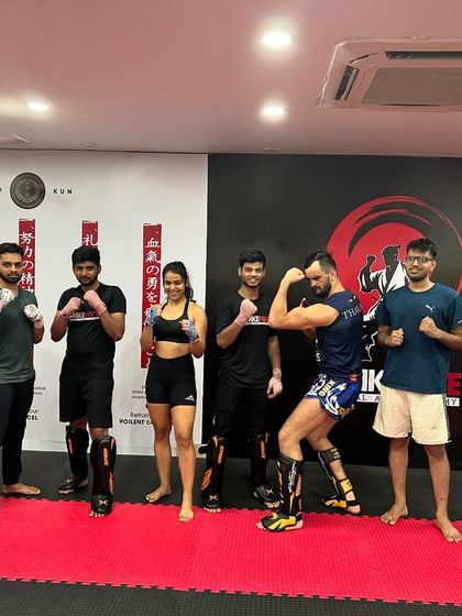 The class poses with a guest coach after an intense session, showing our commitment to bringing diverse expertise to our students.