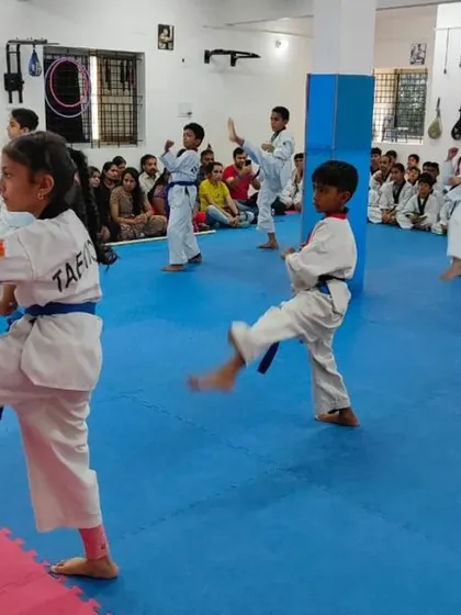 A student practices a front kick.