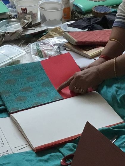 A close-up of a beautifully crafted book made from upcycled materials. Our workshops show how waste can be transformed into something valuable and artistic.