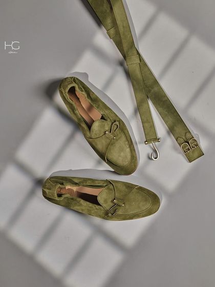 A flat lay of the olive suede loafers and a matching belt. Coordinating accessories is a simple way to create a polished and intentional look.