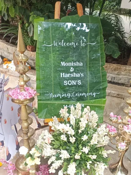 I love mixing modern and traditional elements. This custom acrylic welcome sign for a naming ceremony is placed on a fresh banana leaf background for a unique touch.