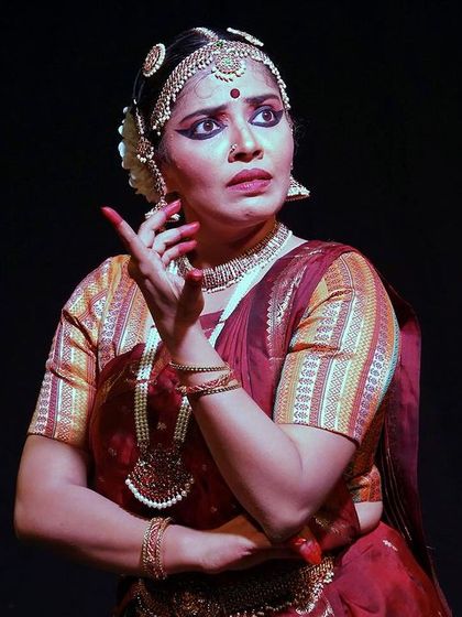 A close-up of the dancer from 'Rasayatra', her expressive face conveying a world of emotion. Our intimate stage allows the audience to appreciate these subtle yet powerful details.