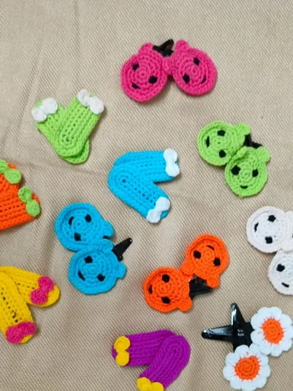 A collection of my colourful and fun hair clips. I have made them in many shapes like little footballs, watermelons, and cherries. These handmade clips are a cute accessory for any hairstyle.