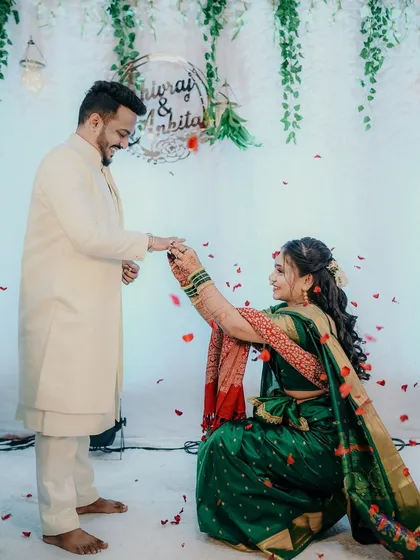 A wonderful reversal of tradition, with the bride kneeling to put the ring on the groom's finger. This moment was full of laughter and joy, showing the couple's modern and playful dynamic.