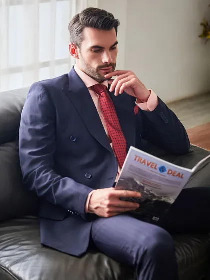 Taking a moment to read, this shot shows the suit in a natural, relaxed state. The fabric drapes perfectly, showcasing the quality of both the material and the tailoring.