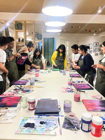 A team gathers around their abstract paintings, discussing techniques and admiring each other's work. It's a great way to see a different, more creative side of your colleagues.
