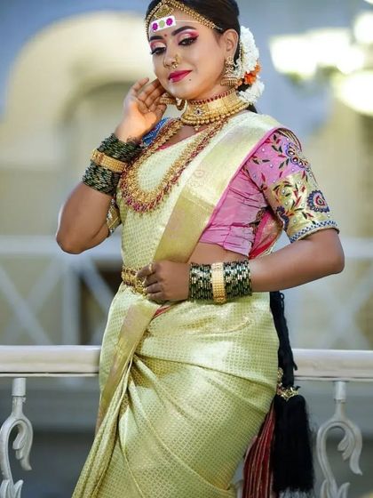 A full-length view of a bride, showcasing the elegance of the saree and the grandeur of our complete temple jewellery set.