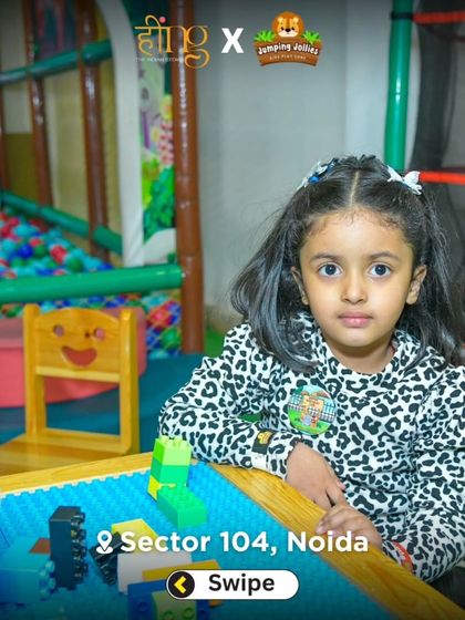 A quiet moment of creativity. This little girl is focused on building with blocks at one of our kid-sized tables in the toddler area.