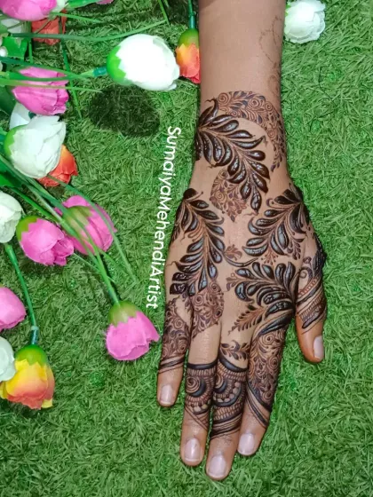 Just a girl who loves mehendi. This bold, leafy design covers the back of the hand in a beautiful, flowing pattern.
