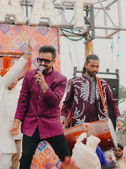 Sharing a moment with the groom's father during the baraat. It's a celebration for the entire family, and I make sure everyone feels the excitement.