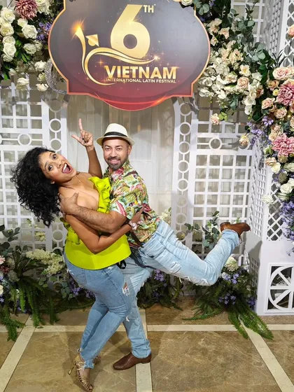 A playful, fun pose against the beautiful floral backdrop at the Vietnam festival. It’s not just about dancing, but also about creating joyful memories.