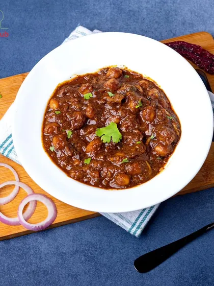 A taste of tradition with our Amritsari Chhole. This classic Punjabi dish is full of flavor, made with chickpeas simmered in a tangy, spiced gravy. It's pure comfort in a bowl.