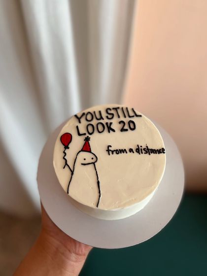 This cake brings a classic joke to life, featuring the Flork meme character and the text "You still look 20 from a distance."
