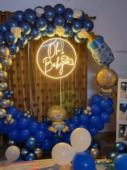 A clear, straight-on view of the blue and silver "Oh Baby" welcome decoration.
