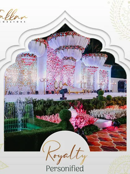 Royalty personified in this grand wedding stage. The design features massive floral chandeliers and a backdrop of thousands of flowers, creating a breathtaking scene of white, pink, and red.