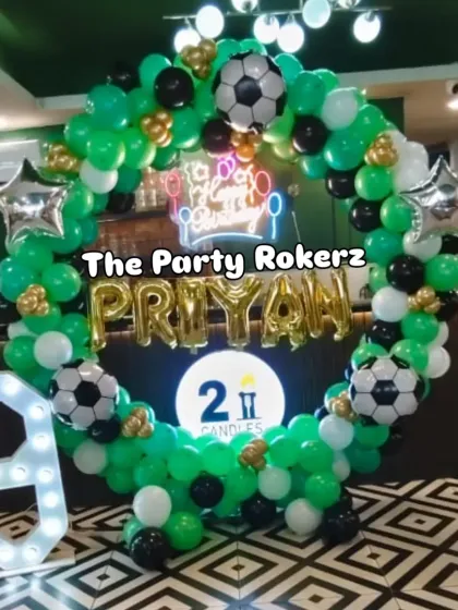 Another angle of the football-themed decor, showing the full circular balloon arch and the placement of the marquee number.