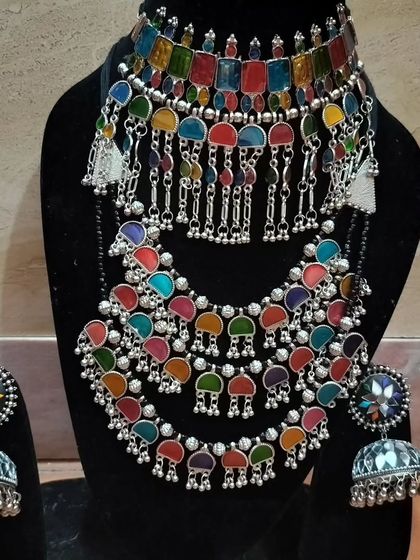 A multi-colored oxidised set with large jhumkas, perfect for pairing with a colorful Garba outfit.