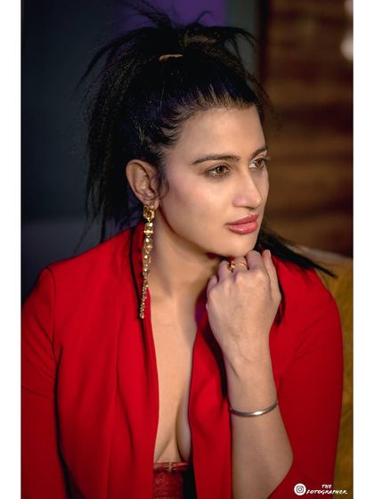 A close-up portrait that captures a pensive, elegant expression. The lighting is carefully controlled to highlight features and create a sophisticated mood.