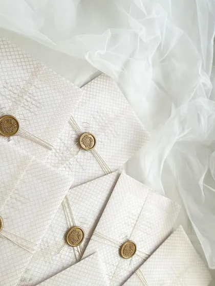 Everything for my sister's wedding invitation was done in-house. This is the final wrapped package, with a vellum overlay, string, and a custom wax seal.