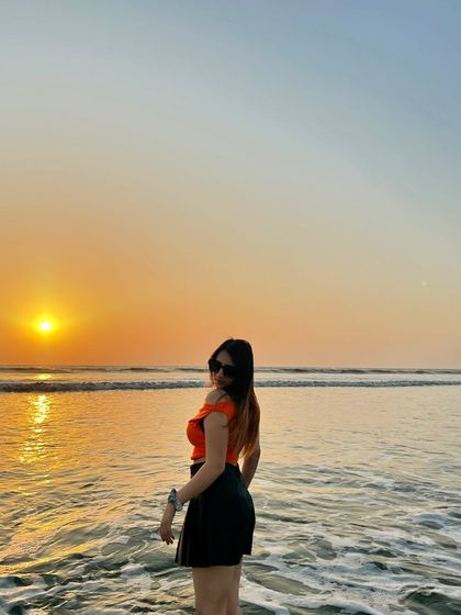 Turning to face the camera during the golden hour sunset. The lighting is perfect and creates a warm, magical glow.