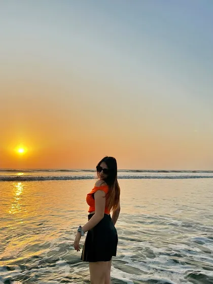 Turning to face the camera during the golden hour sunset. The lighting is perfect and creates a warm, magical glow.