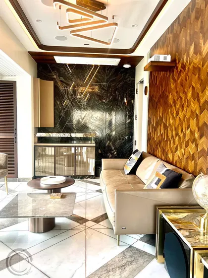 A recently finished project in the heart of the city. This space combines a chevron-patterned wood wall, a dark marble bar area, and geometric floor inlays to create a dynamic and luxurious environment.