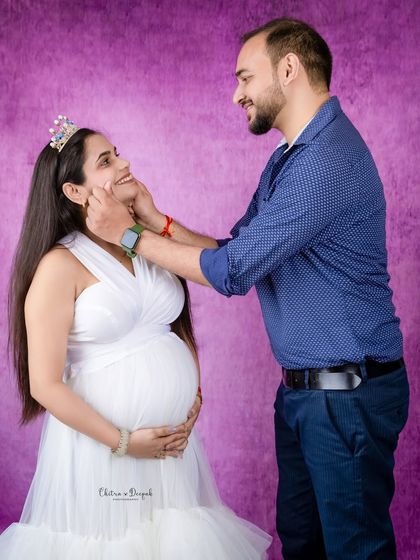 A sweet, playful moment between the couple. His gentle touch and her happy smile make this a truly heartwarming photo.