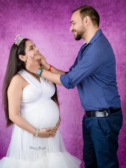 A sweet, playful moment between the couple. His gentle touch and her happy smile make this a truly heartwarming photo.