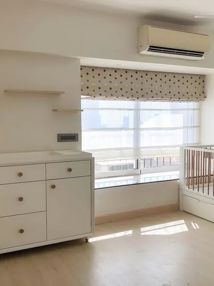 For this nursery, we went with a modern and neutral theme. The clean lines of the white furniture, light wood floors, and simple house-shaped shelves create a bright, airy, and calming environment.