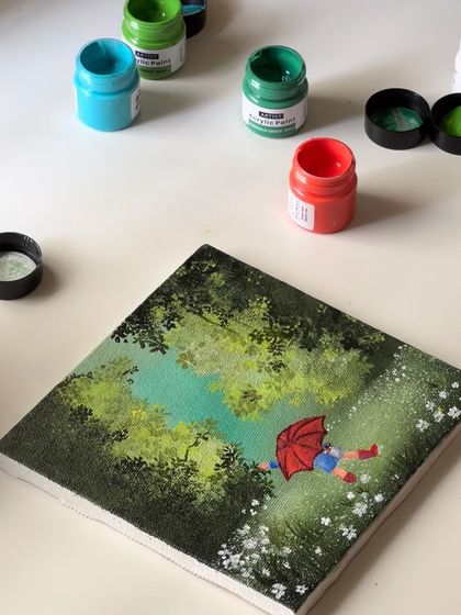 The rainy day painting on my desk, surrounded by the acrylic paints I used to create it.