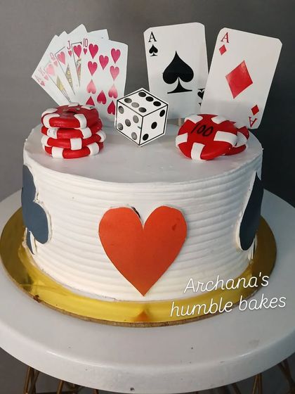 A simple and fun poker-themed cake with playing cards and chips.