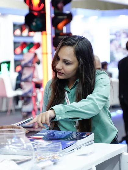 Our team member guiding a visitor through our product catalog at the Traffic Infra Tech Expo 2023.