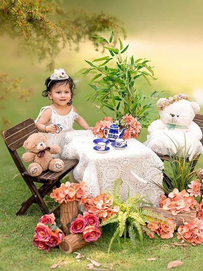 An outdoor tea party with some furry friends. This whimsical setup in a natural setting is perfect for creating magical childhood memories.
