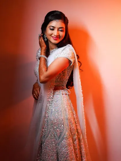 A full-length view of Rakshita's elegant light blue reception lehenga, paired with soft waves and a glowing makeup look.
